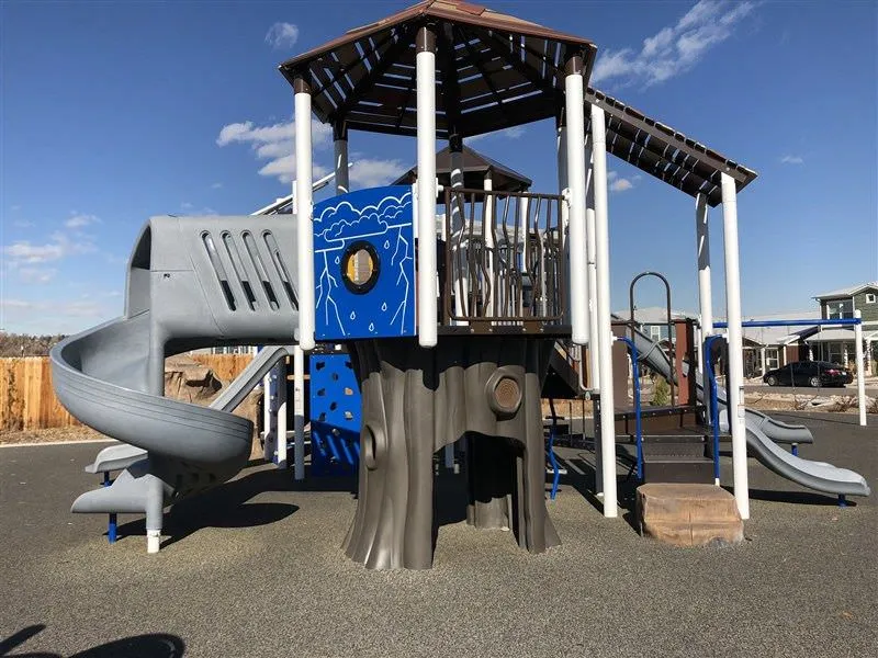 Tree fort playground equipment with winding slide at Sheridan Square Park